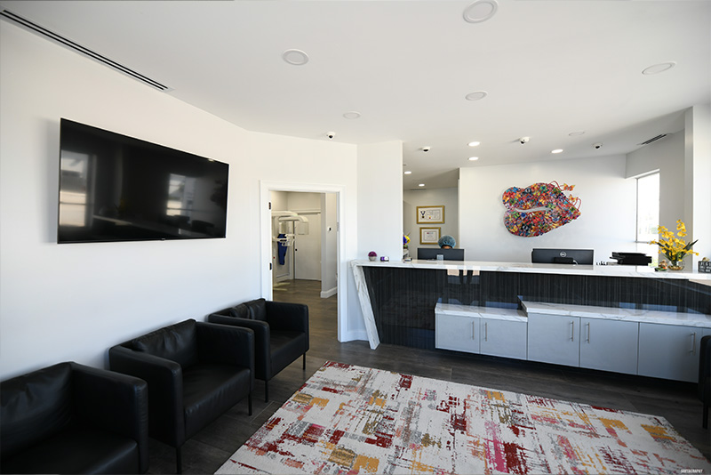 The image shows an interior space, likely a lobby or waiting area of a building, featuring modern furnishings and decor.