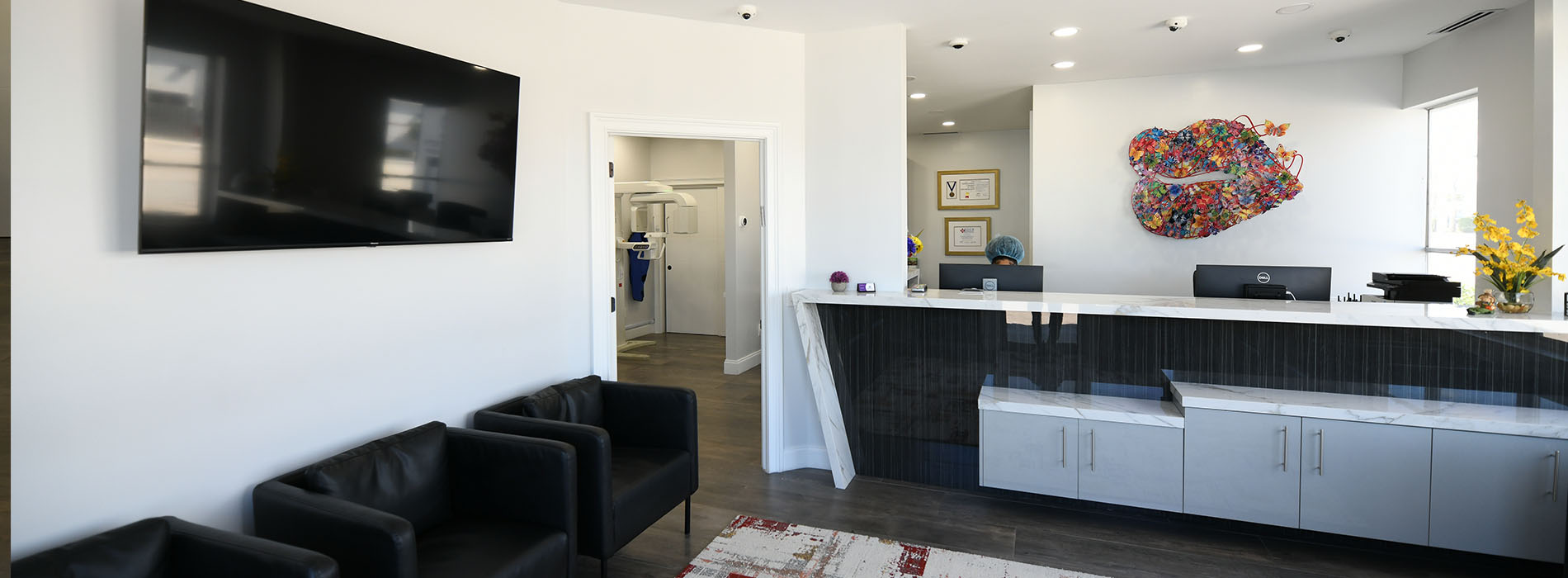 An interior view of a modern office space with a reception area, featuring contemporary furniture and decor.