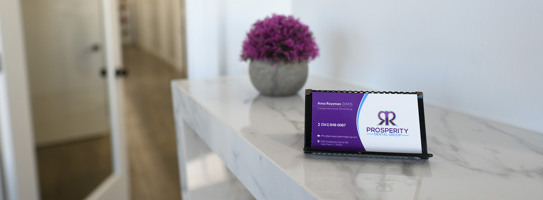 The image shows a sign with the text 'Real Estate' placed on a surface, likely in an office or real estate setting.