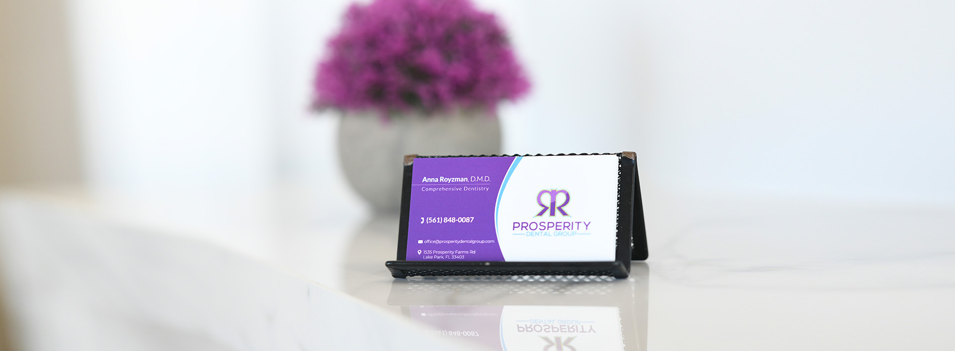 An image of a product, possibly a label or sign, with the text 'Raspberry Ketones' visible on it, set against a blurred background that includes a vase and a table.