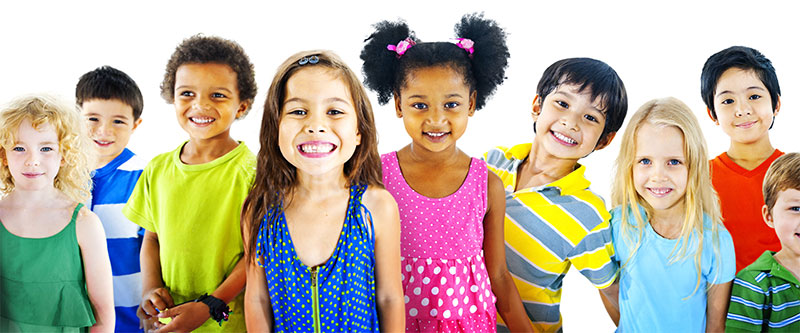 A diverse group of children posing for a photo, with various ethnicities and clothing colors, against a plain background.