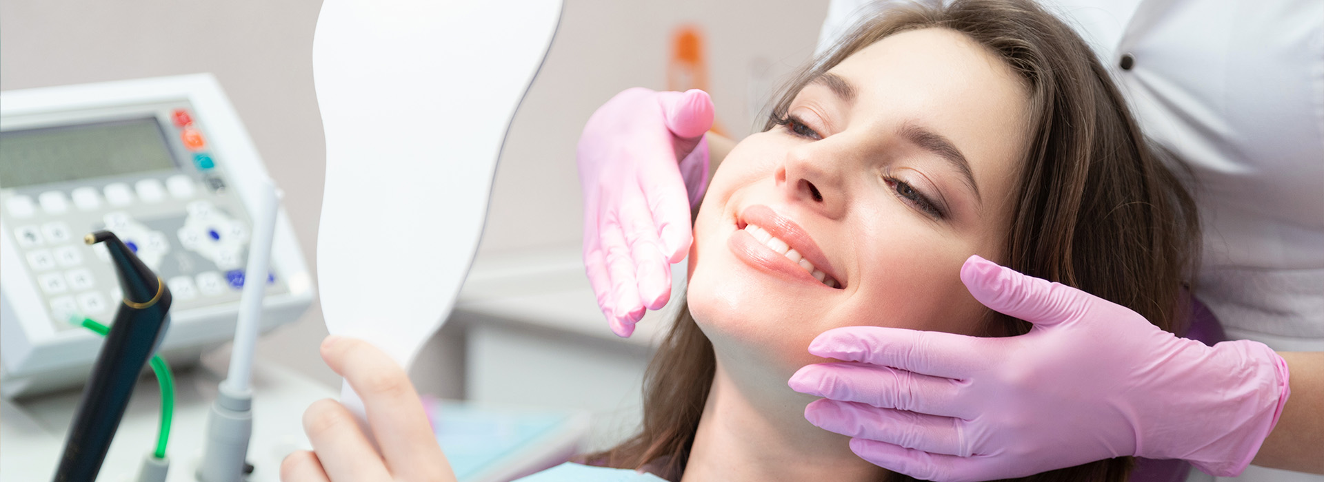 Woman receiving dental care in a professional setting, with a smiling expression.